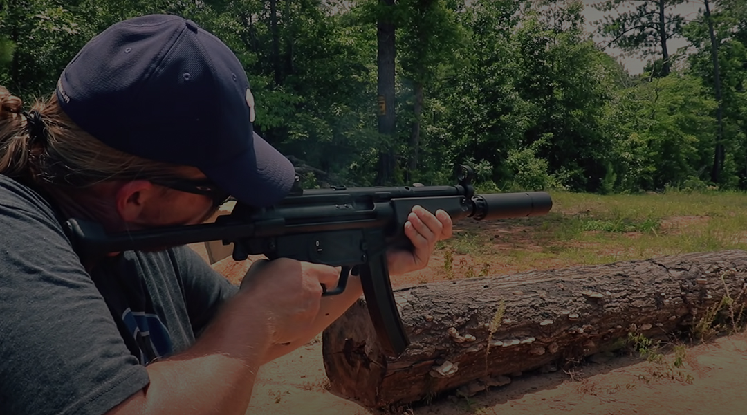 Man Shooting a Rifle equipped with a Wolfman Silencer and Key Micro adapter